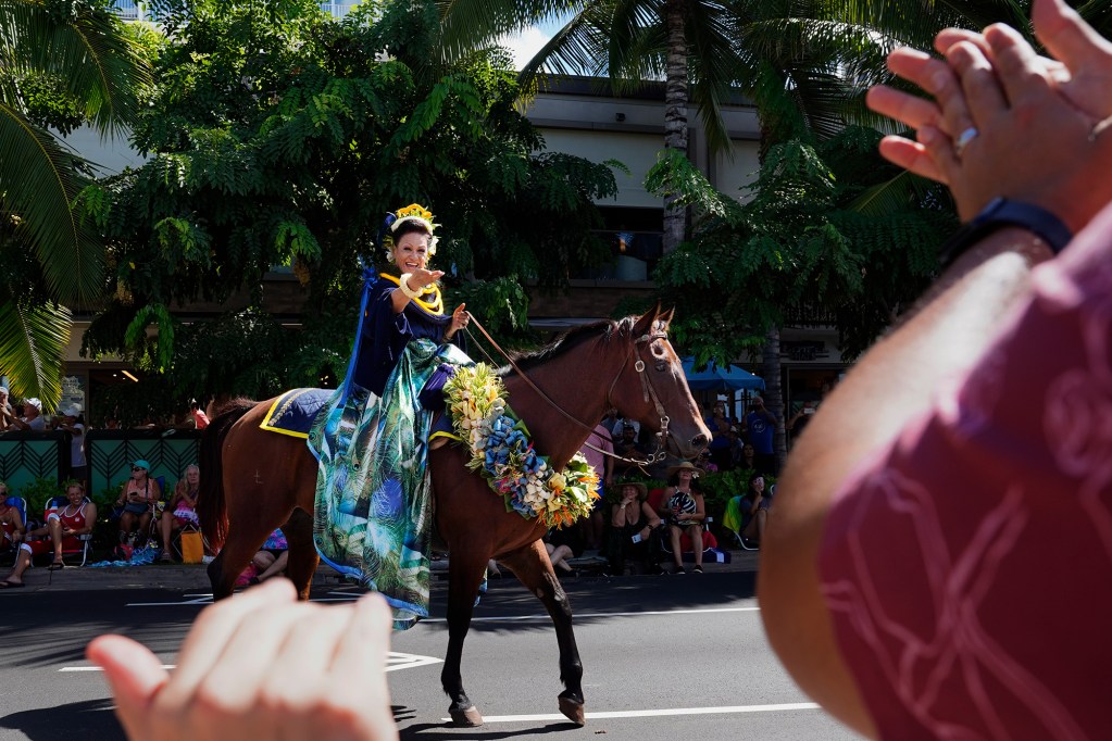 Pau Queen Leialoha Amina recognizes people along the Aloha Festivals 76th Annual Floral Parade Saturday, Sept. 25, 2024, in Honolulu. (Kevin Fujii/Civil Beat/2024)