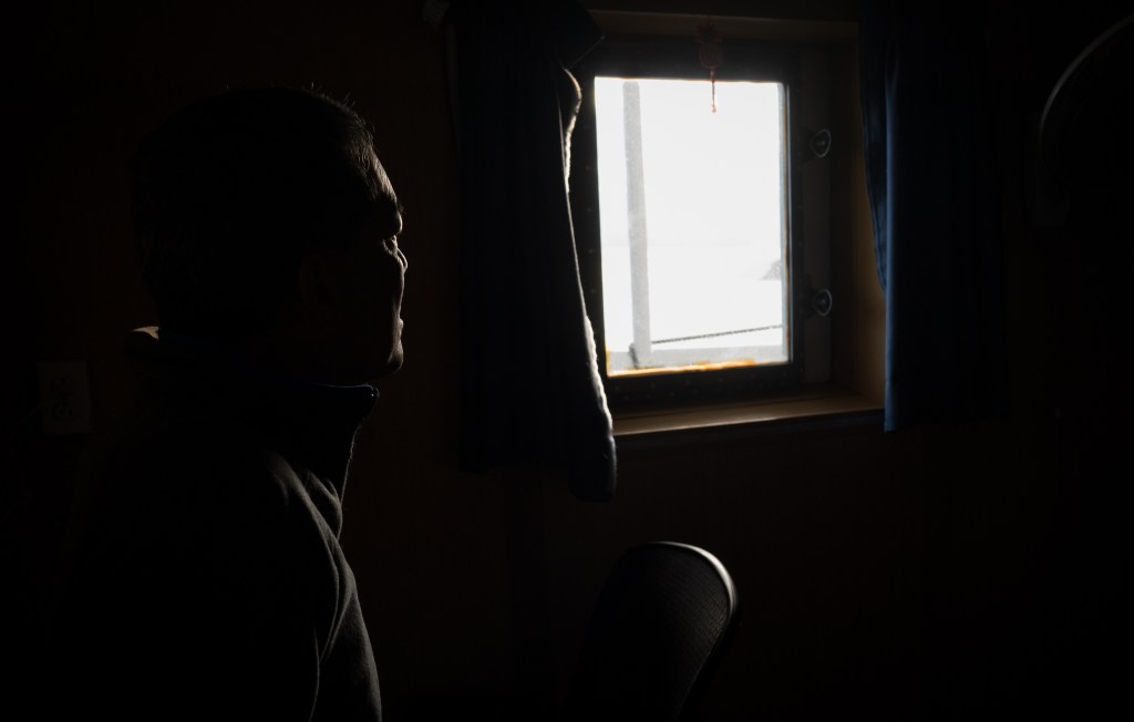 NOAA chief scientist Randy Kosaki looks out the window in his stateroom while the Oscar Elton Sette is underway in Papahanaumokuakea. (Nathan Eagle/Civil Beat/2024)