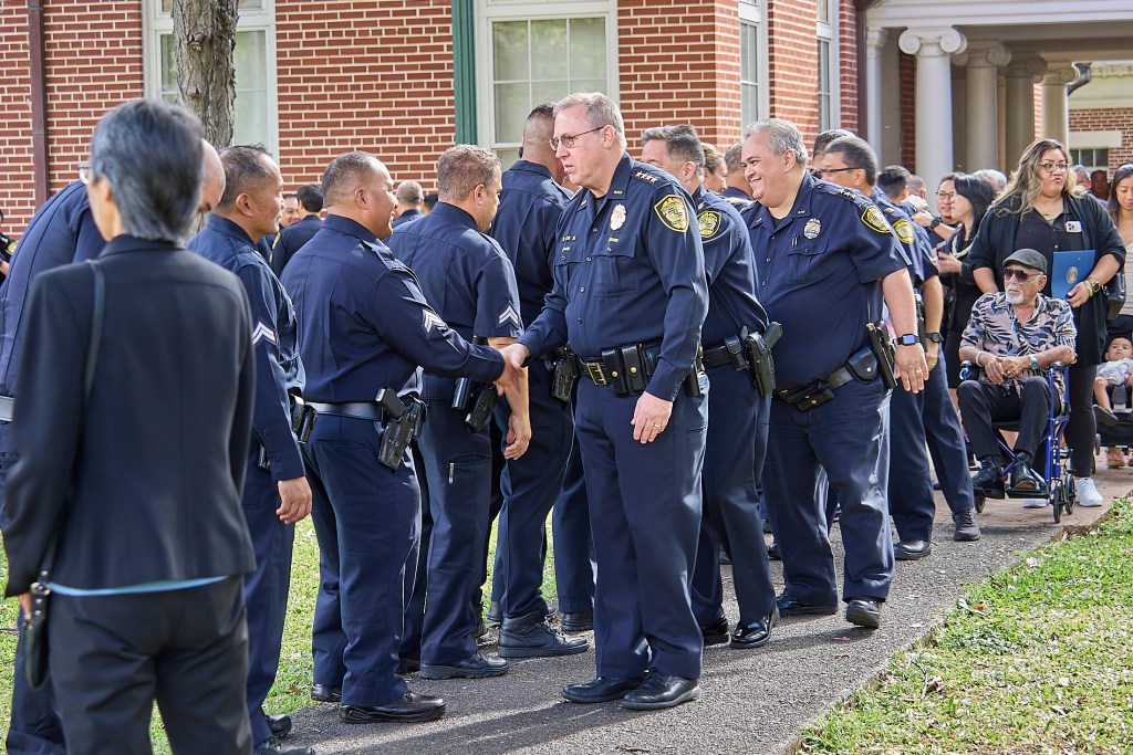 Forty-five officers and civilians were recognized during a promotion ceremony at the Mission Memorial Auditorium on November 19th.  Chief Joe Logan greets newly promoted Corporal Ritchie Langit and the rest of the promoted HPD officers following the ceremony.(David Croxford/Civil Beat/2024)