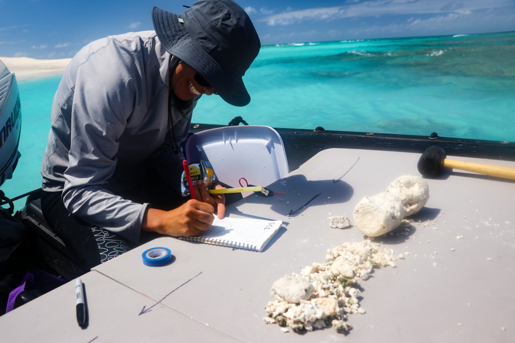 Scientist Haunani Kane takes notes from a core sample drilled off the coast of East Island in 2018. (Alana Eagle/Civil Beat/2024)