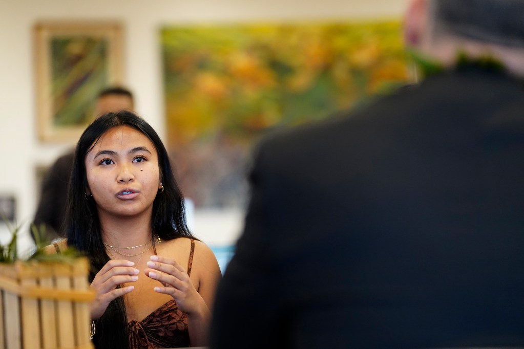 Lahainaluna High School student leader Karisa Bayudan, talks with U.S. Department of Education Sec. Miguel Cardona during his West Maui tour Friday, Dec. 6, 2024, in Lahaina. (Kevin Fujii/Civil Beat/2024)