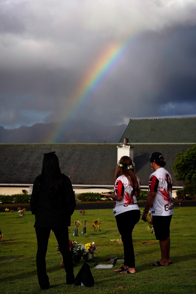 A rainbow forms while visiting Theresa Cachuela’s grave Sunday, Dec. 15, 2024, at the Mililani Memorial Park and Mortuary in Mililani. Theresa was killed almost one year ago by her estranged husband Jason Cachuela despite a temporary restraining order. (Kevin Fujii/Civil Beat/2024)