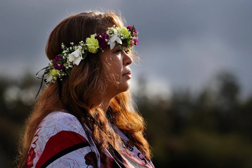 Lucita Ani-Nihoa listens to her daughter’s best friend Mae Nani Knight at Theresa Cachuela’s grave Sunday, Dec. 15, 2024, at the Mililani Memorial Park and Mortuary in Mililani. The mother and best friend of Theresa invited Civil Beat to visit her gravesite almost one year after she was killed by her estranged husband Jason Cachuela despite a temporary restraining order. (Kevin Fujii/Civil Beat/2024)