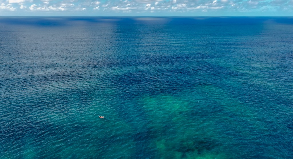 A small rigid hull inflatable boat nears a dive site at Manawai, also known as Pearl and Hermes, in Papahanaumokuakea Marine National Monument in September. (Nathan Eagle/Civil Beat/2024)