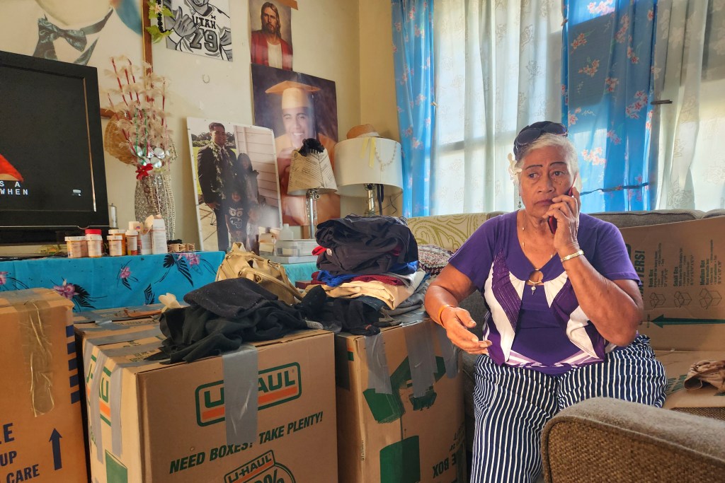 Lutita Momosea, a resident of Kuhio Homes sits among packed boxes. She is one of several that are being forced to leave their homes so that renovations and reconstruction can occur.(Jeremy Hay/Civil Beat/2025)