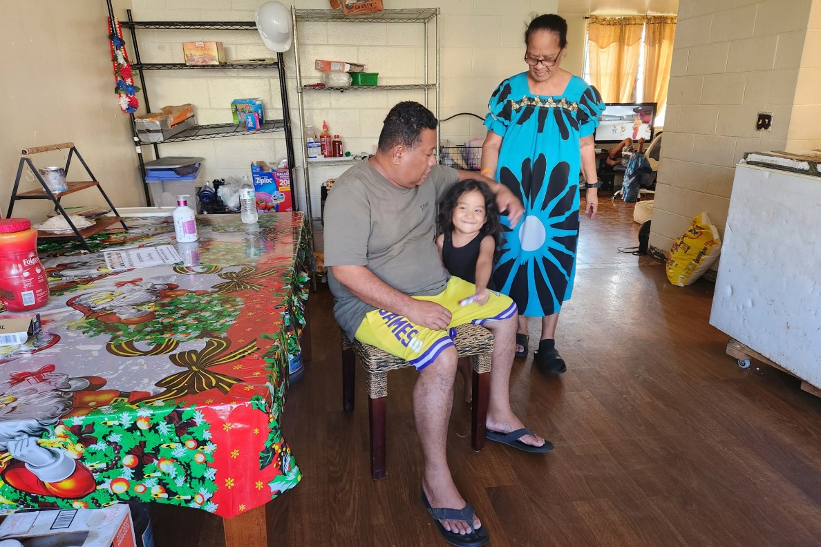 Ten (L) and Tirimita Nifaro with their granddaughter Nayann are Kūhiō Park Terrace residents who are being forced to leave their homes so a redevelopment project can move forward to build more affordable housing.(Jeremy Hay/Civil Beat/2025)