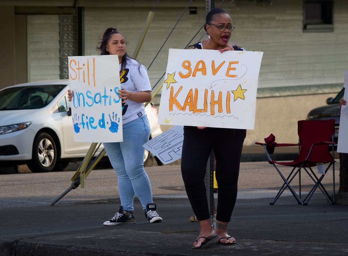 Lehua Willets (L) and Lenda Tominiko (R) at a weekly protest Kūhiō Park Terrace residents hold at the corner of North School Street and Ahonui Street in Kalihi.(David Croxford/Civil Beat/2025)