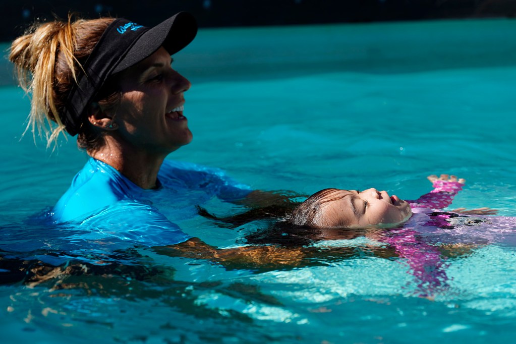 Audrey Harrer works with Kira Kawaoka, 3, to practice floating on her back Tuesday, Feb. 25, 2025, in Waipahu. Water safety is paramount living on an island. (Kevin Fujii/Civil Beat/2025)