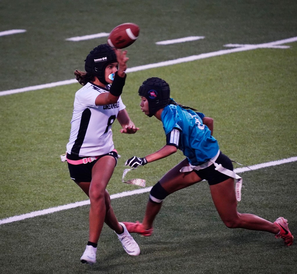 Kapolei’s Lay Kiesel-Mokiao, #6, de-flags Dreamhouse Nā Hōkū quarterback Chevelle Kane, #8, before she can throw a pass during the first Hawai’i high school girls flag football game Tuesday, March 25, 2025, at Wai’anae High School in Wai’anae. (Kevin Fujii/Civil Beat/2025)