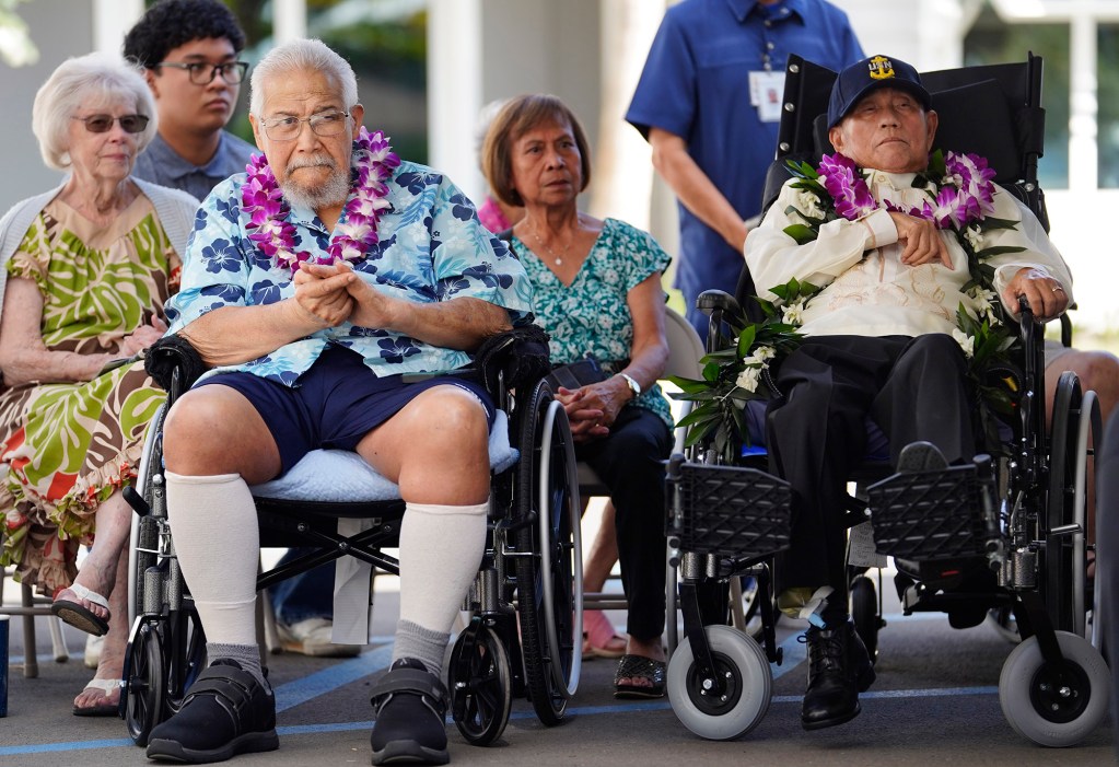 Residents of the Daniel K. Akaka State Veterans Home Markham Soares, left, and Ricardo Farala applaud during the dedication ceremony Wednesday, March 26, 2025, in Kapolei. (Kevin Fujii/Civil Beat/2025)