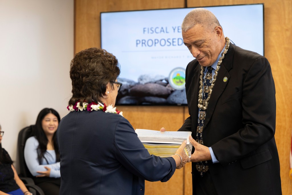 Maui Mayor Richard Bissen presented his proposed $1.51 billion budget for fiscal year 2026 to County Council Chair Alice Lee last week. (Courtesy: Maui County/2025)