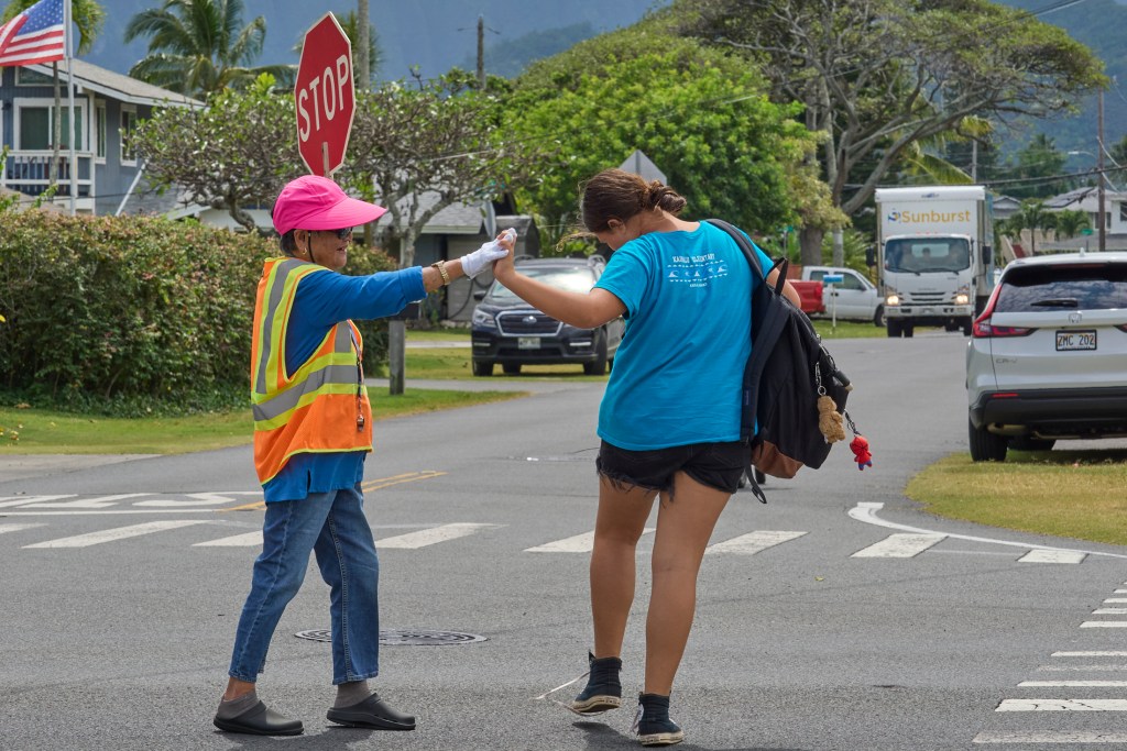 Elsie Miyashiro guards the intersection of 662 N. Kainalu Drive and Kaha Streets in Kailua. ItÕs a small but busy intersection behind Kainalu Elementary school.  Miyashiro was photographed on Thursday April 3rd during her afternoon shift. (David Croxford/Civil Beat/2025)