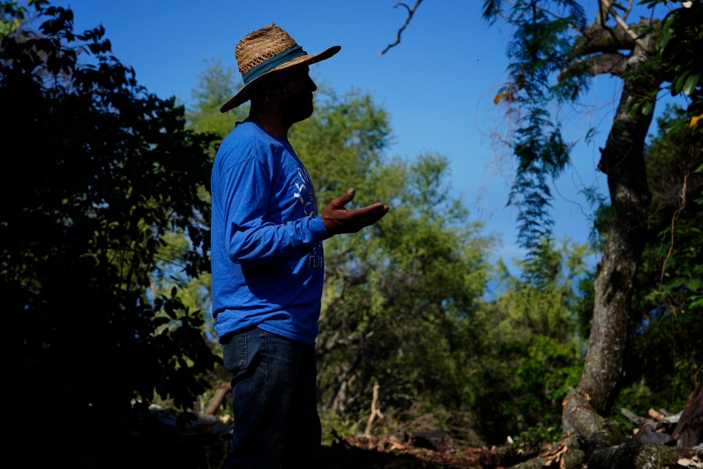 Juan P. talks with Honolulu Civil Beat while clearing land Wednesday, April 30, 2025, in South Kona. Juan is concerned about recent immigration raids on the Big Island where he works and lives undocumented. (Kevin Fujii/Civil Beat/2025)