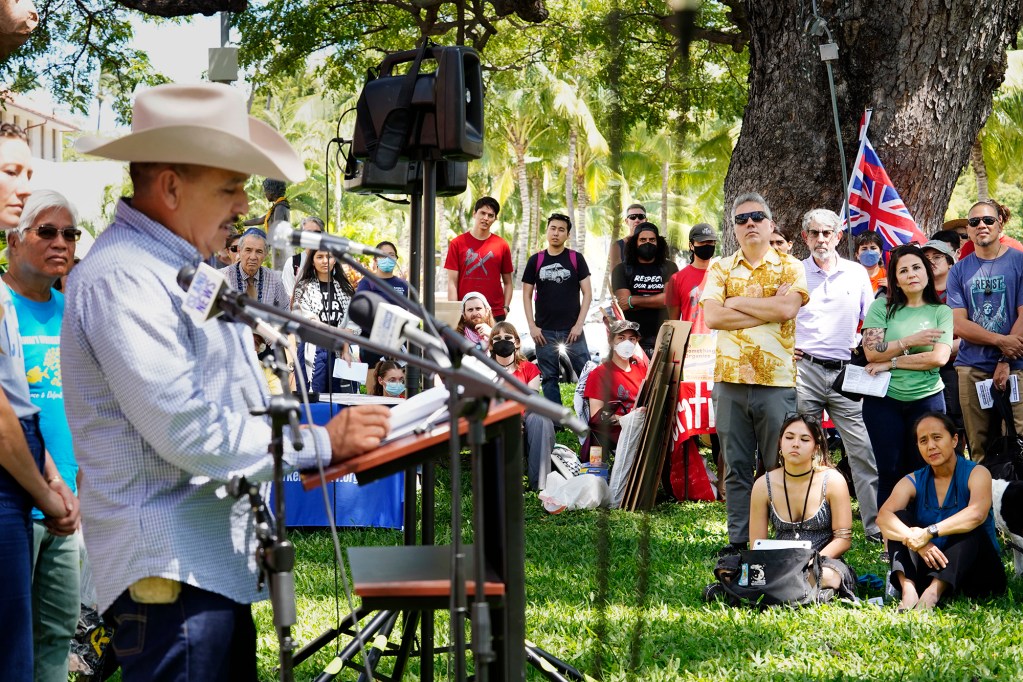 The crowd listens to Armando Rodriguez, a Big Island coffee farmer, speaking on behalf of the Hawaiʻi Coalition for Immigrant Rights Thursday, May 1, 2025, in Honolulu. Rodriguez spoke about his journey to becoming an American citizen and the fear current undocumented workers have. (Kevin Fujii/Civil Beat/2025)