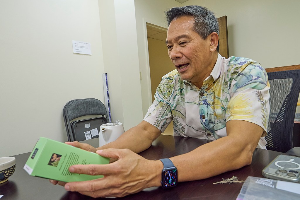 Byron Goo processes Mamaki Tea into pure 100% Mamaki Tea as well as blends that include Mint and other herbs and spices.  A new bill presently on the Governor’s Desk for signing would eliminate Goo’s ability to see the blends and place his entire business into a precarious situation, possibly forcing it’s closure.(David Croxford/Civil Beat/2025)