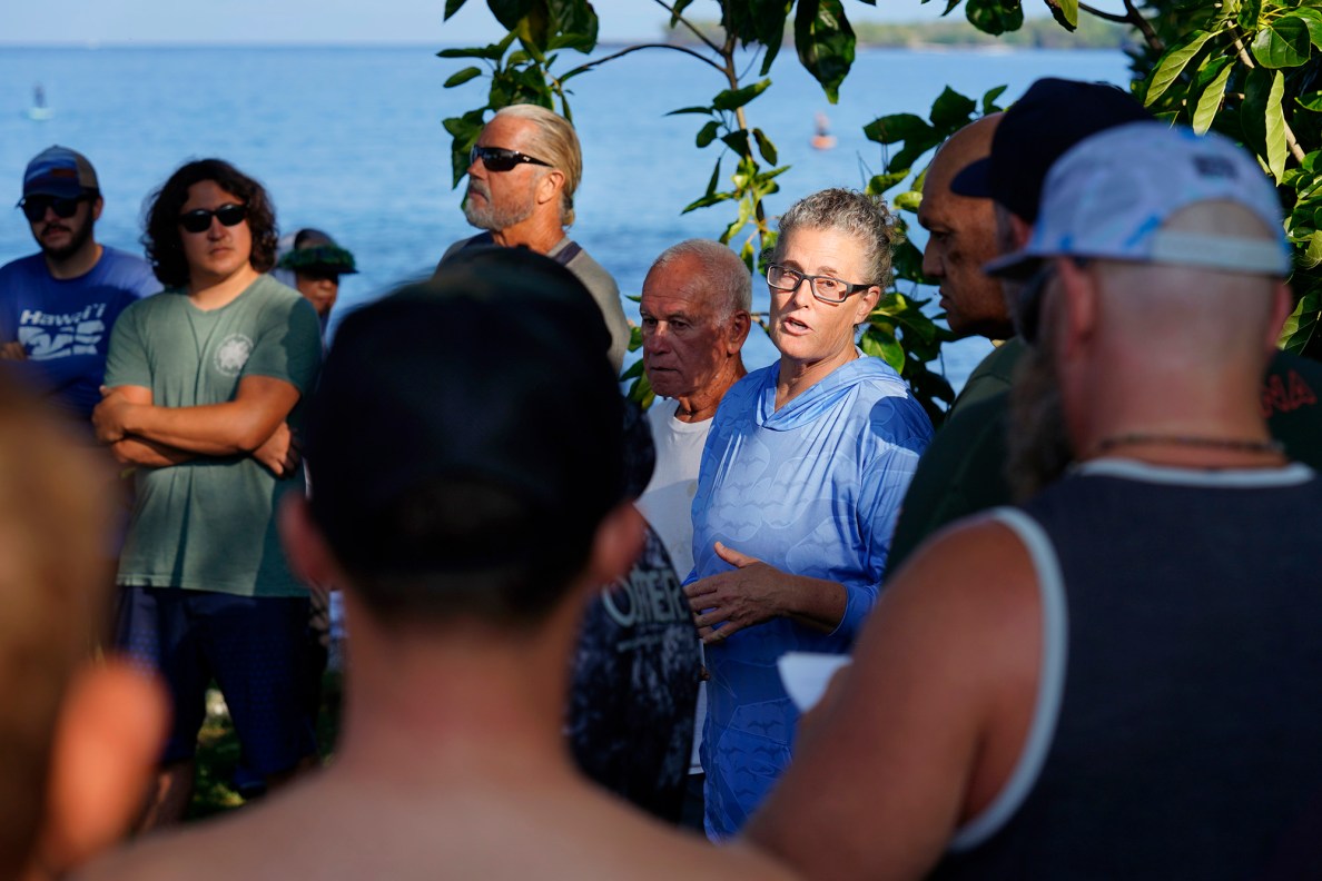 Aunty Krista Johnson, right, welcomes competitors to spearfish for the first time since 1969 during a Kealakekua Bay Non-Native I‘a (fish) Removal Event Sunday, May 18, 2025, in Captain Cook. Other organizers Uncle Chuck, Charles Kealoha Leslie, and Uncle Bill Morris stand with Johnson. Spearfishing has been banned for the past  56 years after Kealakekua Bay was designated a Marine Life Conservation District, or MLCD. (Kevin Fujii/Civil Beat/2025)
