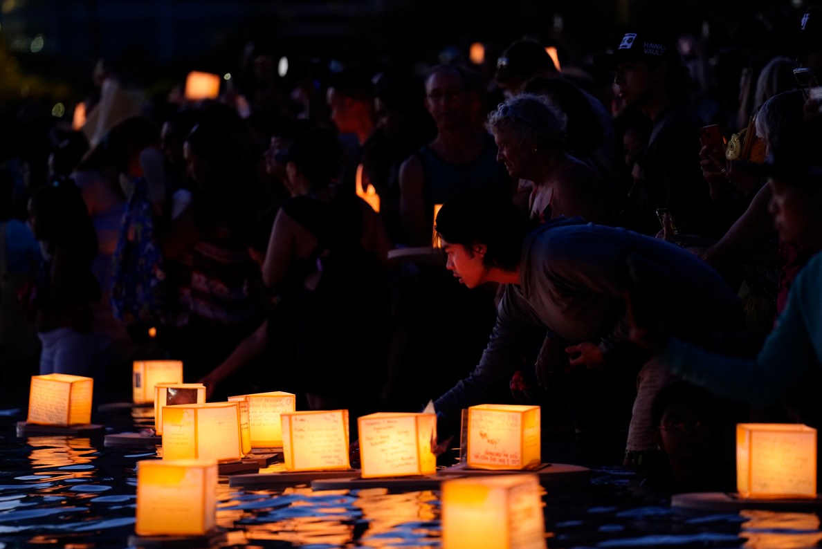 Robin Cartago, of Honolulu, sends off his lantern remembering friends and family during the 27th Annual Shinnyo Lantern Floating Hawaiʻi at Ala Moana Regional Park Monday, May 26, 2025, in Honolulu. 6,000 lanterns with messages to lost loved ones are launched by family members. (Kevin Fujii/Civil Beat/2025)