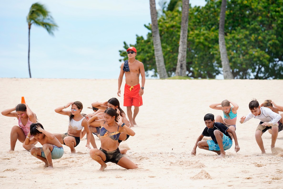 Honolulu Ocean Safety Department lifeguard Jedidiah Wataru runs Junior Lifeguard Program participants through beach fitness exercises at Ko’olina Wednesday, June 25, 2025, in Kapolei. (Kevin Fujii/Civil Beat/2025)