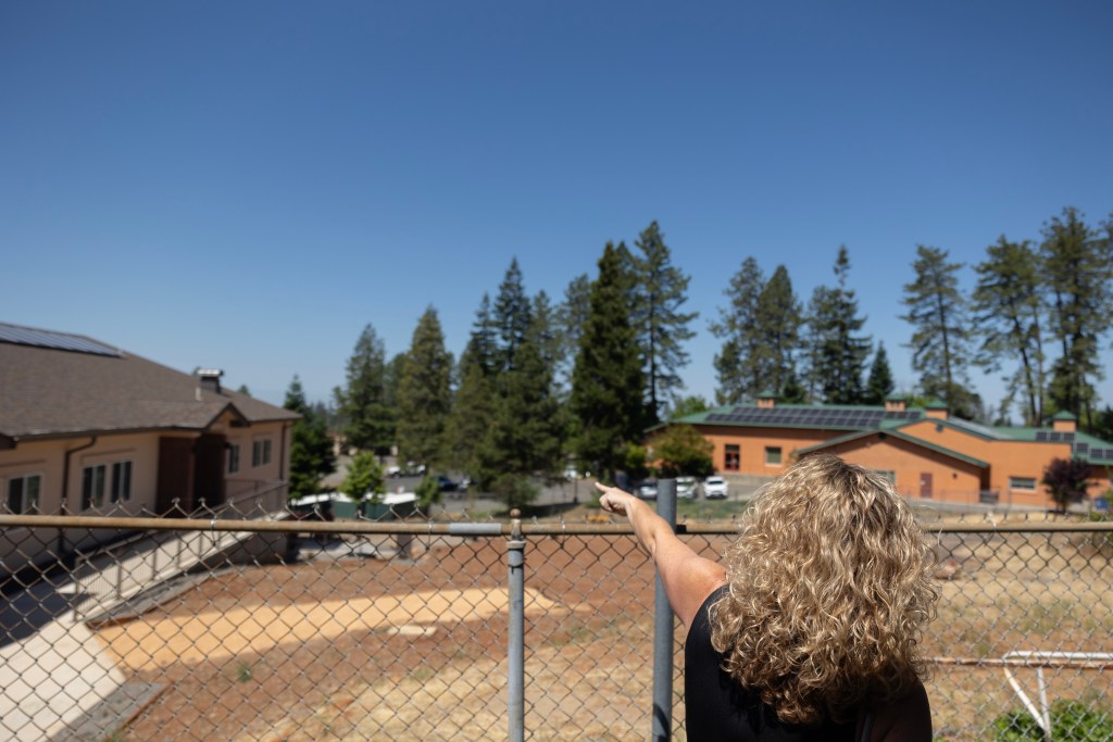 Superintendent Casey Taylor of Achieve Academy School of Paradise, points to areas near campus that were impacted by the Paradise Fire, in Paradise on May 21, 2025. Photo by Miguel Gutierrez Jr., CalMatters