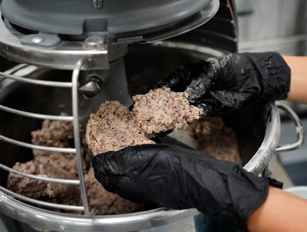 Jina Wye checks her limu-cracker batter at the Wahiawā Value-Added Product Development Center Wednesday, Sept. 17, 2025, in Wahiawā. The center makes producing her “Made in Hawaiʻi” crackers easier with facilities and amenities usually owned by mass-production companies. (Kevin Fujii/Civil Beat/2025)