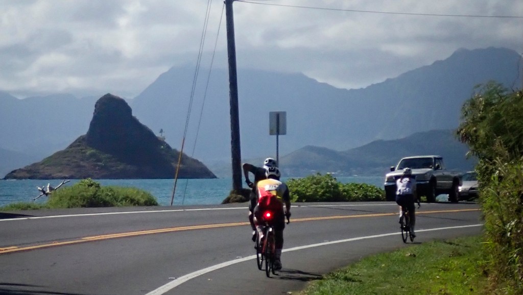 Mokoli‘i rises from the ocean as Hawaiʻi Bicycling League’s annual Honolulu Century Ride riders return to the start along Kamehameha Highway Sunday, Sept. 28, 2025, in Honolulu. (Kevin Fujii/Civil Beat/2025)