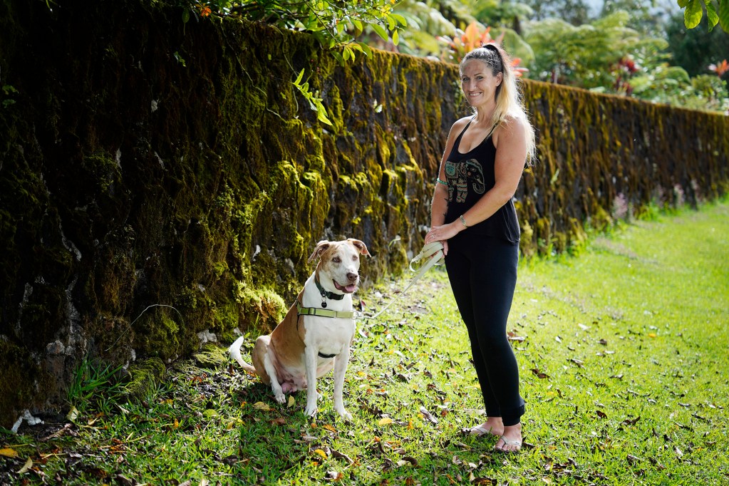 Heather Hofferbert and her dog Trippy are photographed Friday, Oct. 31, 2025, in Hilo. The two were staying in a domestic-abuse shelter and were forced to move to Hilo after funding was cut. (Kevin Fujii/Civil Beat/2025)