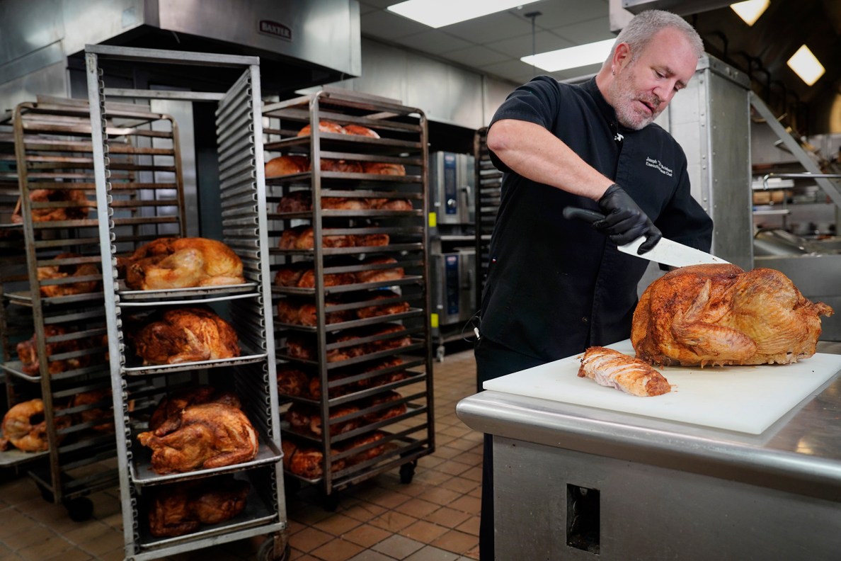 Hilton Hawaiian Village Executive Sous Chef Joseph “JJ” Reinhart slices a turkey breast for part of the 450 Thanksgiving meals Tuesday, Nov. 25, 2025, in Honolulu. This marks the 30th year the hotel kitchen donates to the Institute for Human Services (IHS). (Kevin Fujii/Civil Beat/2025)