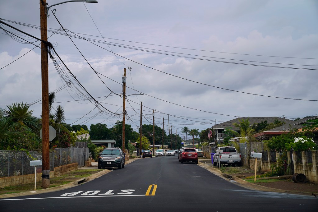 An ʻEwa Beach neighborhood lacks sidewalks at the intersection of Imelda and Auwaha Streets Monday, Dec. 15, 2025. (Kevin Fujii/Civil Beat/2025)