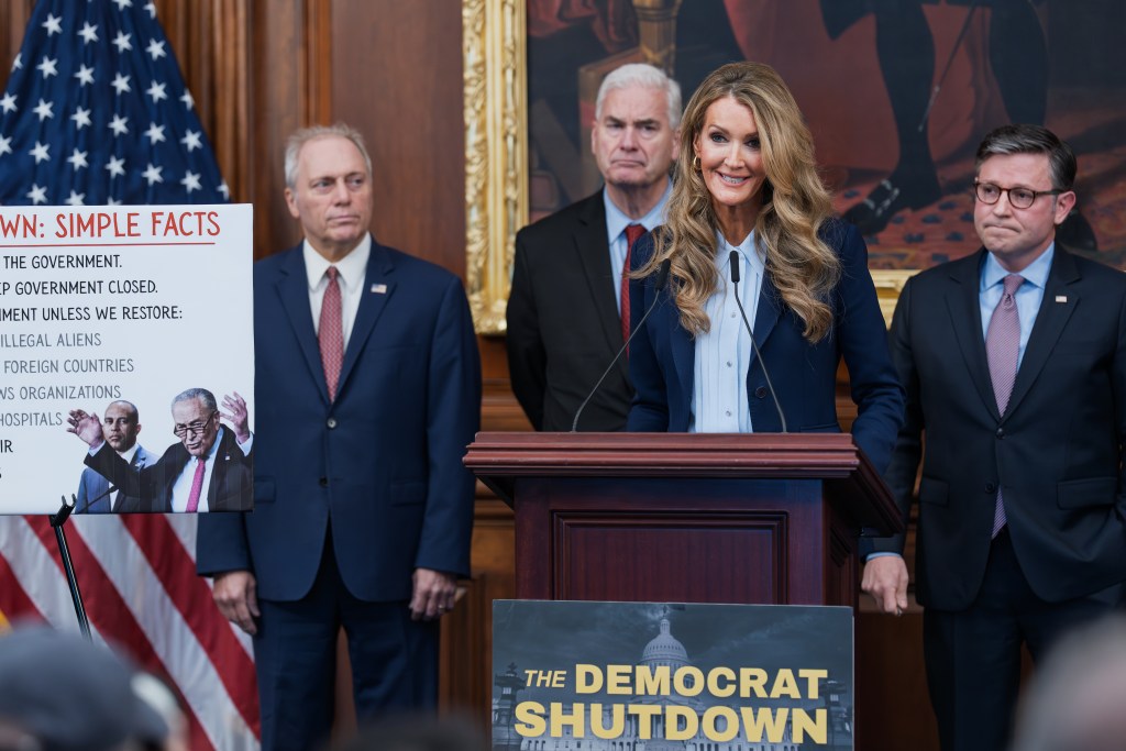 Small Business Administration head Kelly Loeffler, center, is joined by, from left, Majority Leader Steve Scalise, R-La., Majority Whip Tom Emmer, R-Minn., and Speaker of the House Mike Johnson, R-La., at a news conference on day 27 of the government shutdown, at the Capitol in Washington, Monday, Oct. 27, 2025. (AP Photo/J. Scott Applewhite)