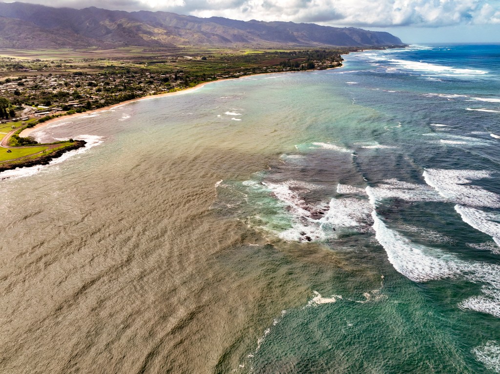 Kaiaka Bay, located on the North Shore of Oʻahu, turns brown after rains wash soil into the waters, Wednesday, Dec. 17, 2025. (Nathan Eagle/Civil Beat/2025)