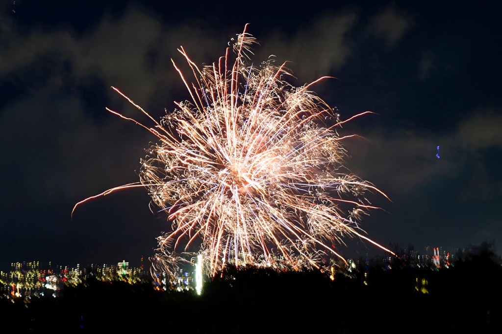 A Department of Law Enforcement drone flies near an aerial firework Wednesday, Dec. 31, 2025, as seen from Waipahu. New laws, the use of aerial drones and citizens heeding the dangers of fireworks noticeably  curbed the annual personal pyrotechnics. (Kevin Fujii/Civil Beat/2025)