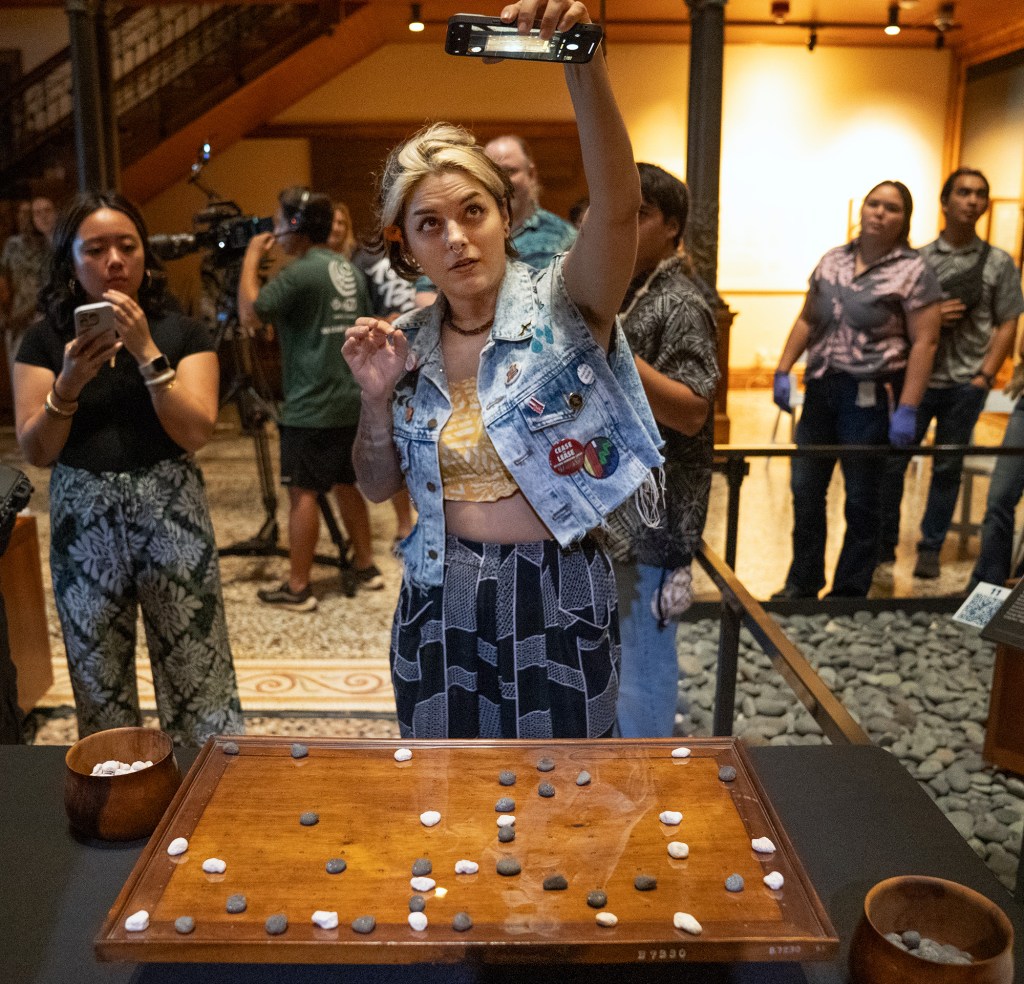 Kūna‘e Kamahele captures the final play Kapena Baptista made against Kahekili Yung on the Kūpuna Papamū to win the inaugural Ka Makou Kōnane Invitational Tournament at the Bishop Museum Friday, Feb. 13, 2026, in Honolulu. (Kevin Fujii/Civil Beat/2026)