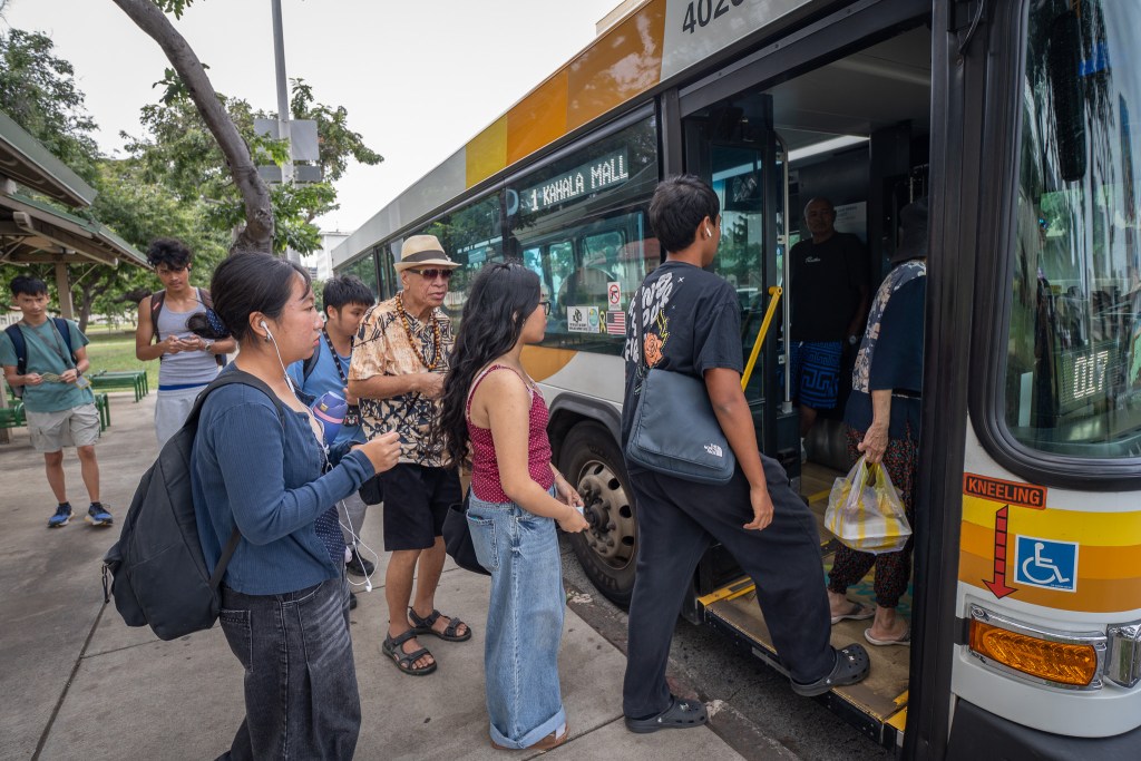 Several McKinley High School students board  a Kahala-bound bus at Pensacola and King Sts in Honolulu, Thursday, Feb. 19, 2026. (Craig Fujii for Civil Beat)