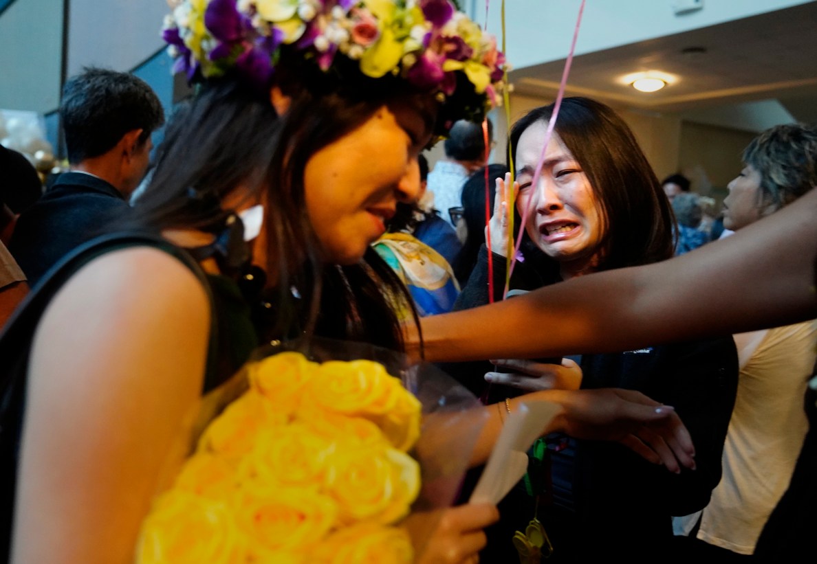 John A. Burns School of Medicine second-year student Kasey Emoto, right, sheds tears of joy for her sister fourth-year student Jamie Emoto after she matched with UC Irvine  Medical Center on “Match Day” Friday, March 20, 2026, in Honolulu. Jamie will continue training in pediatrics. The Emoto sisters are from Lihue. (Kevin Fujii/Civil Beat/2026)