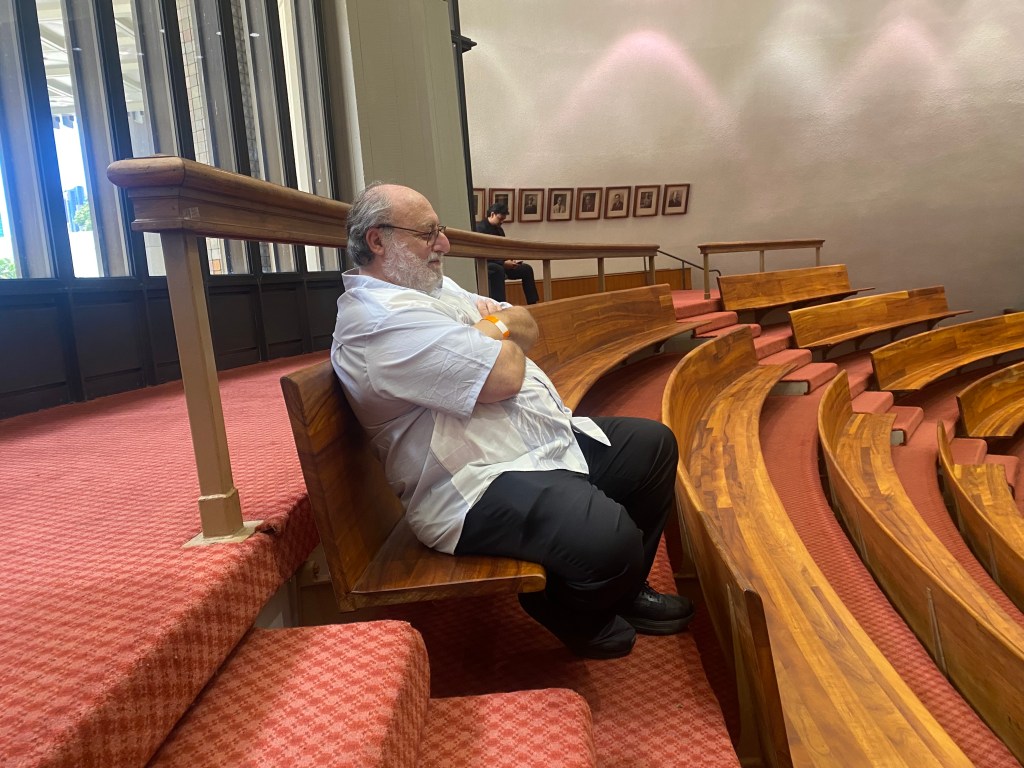 Ali Silvert watches with his arms crossed as the Hawaiʻi House of Representatives shelves a citizen petition he started urging them to investigate a possible case of corruption. (Chad Blair/Civil Beat/2026)