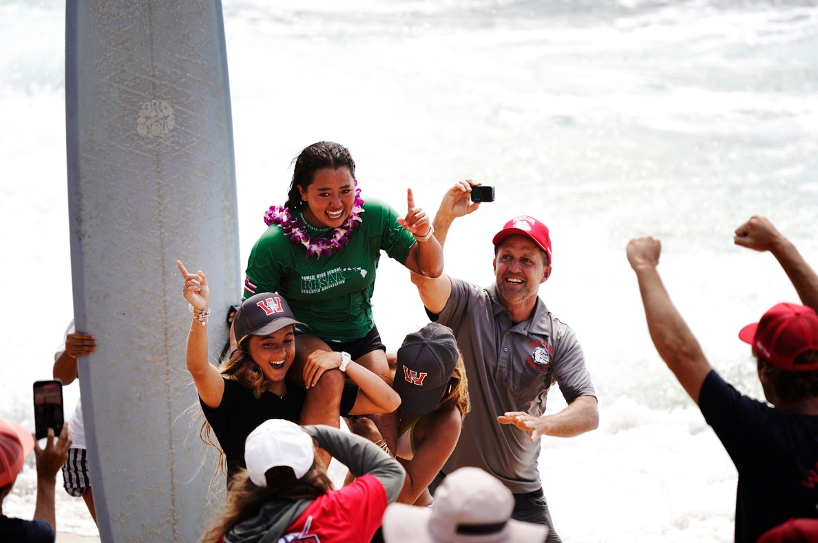 Hanae Rose of Waialua High School gets carried off the beach for winning the inaugural Hawaiʻi High School Athletics Association surfing state championships in girls longboard Saturday, May 2, 2026, at Hoʻokipa Beach Park in Pāʻia. (Kevin Fujii/Civil Beat/2026)