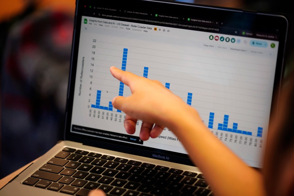 A Kūlia Academy student points out data Thursday, May 7, 2026, in Honolulu. (Kevin Fujii/Civil Beat/2026)