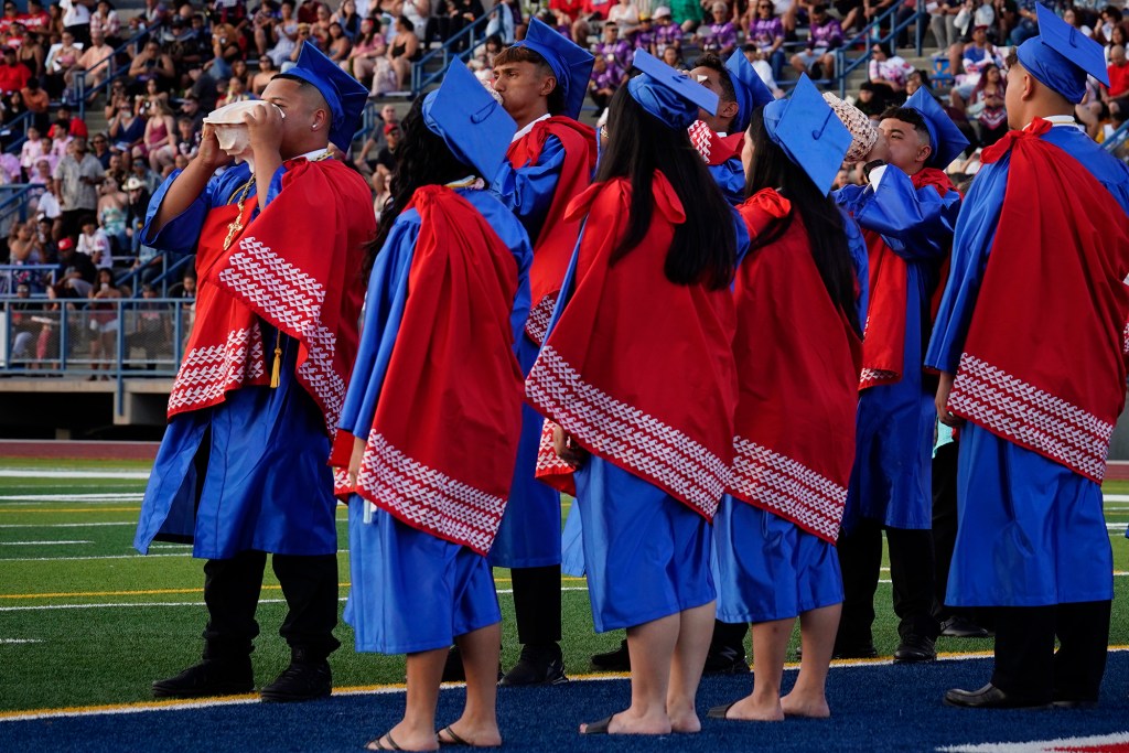 Pū, blowing of the conch shell, begins the Waiʻanae High School commencement ceremony Friday, May 22, 2026, in Waiʻanae. (Kevin Fujii/Civil Beat/2026)