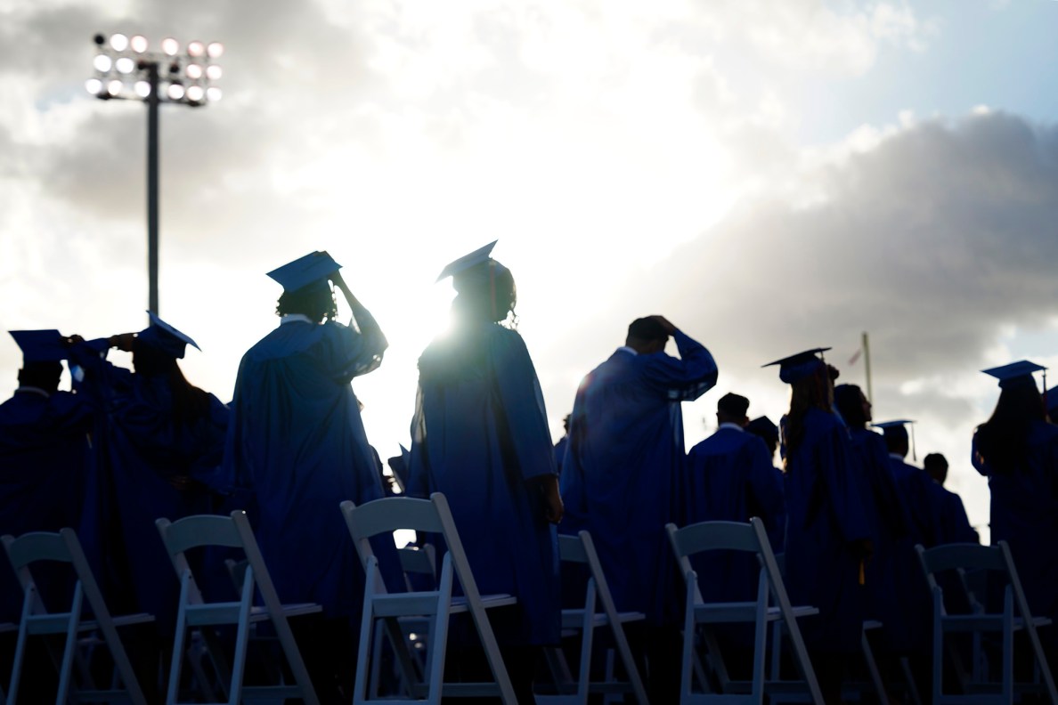 Waiʻanae High School seniors stand as they enter their commencement ceremony Friday, May 22, 2026, in Waiʻanae. (Kevin Fujii/Civil Beat/2026)