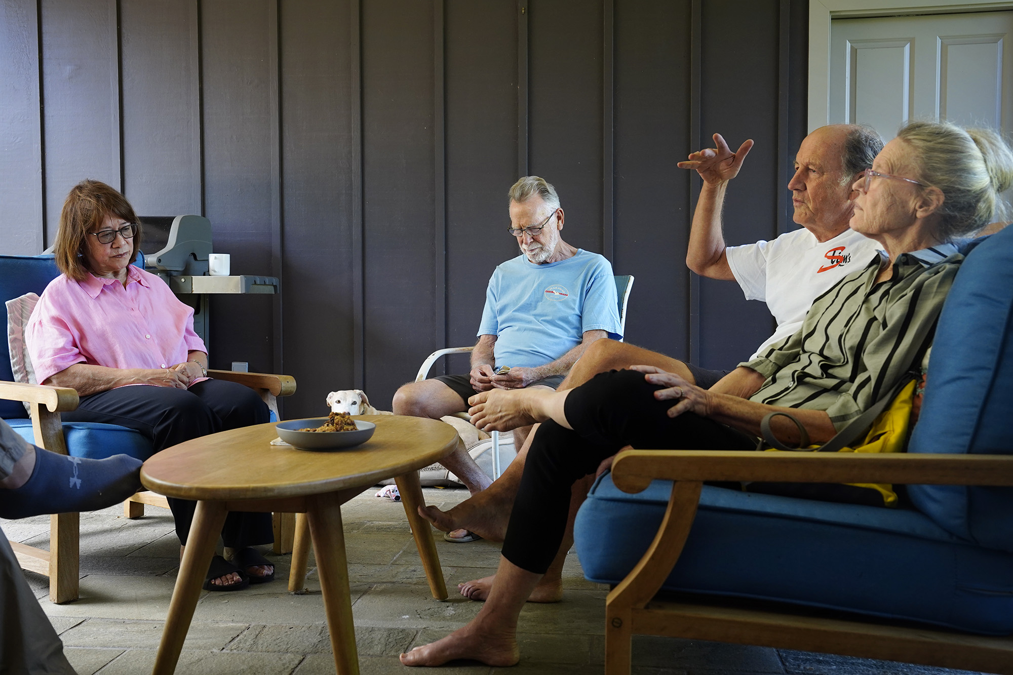 Nalani Clark, from left, Phil Clark, neighbors John Andrews and Elizebeth Keller talk story about exterminating coqui frogs Tuesday, May 26, 2026, in Haʻikū. The two households are part of a neighborhood group who invested in their own sprayer to keep their neighborhood quiet and free from the invasive frogs. (Kevin Fujii/Civil Beat/2024)