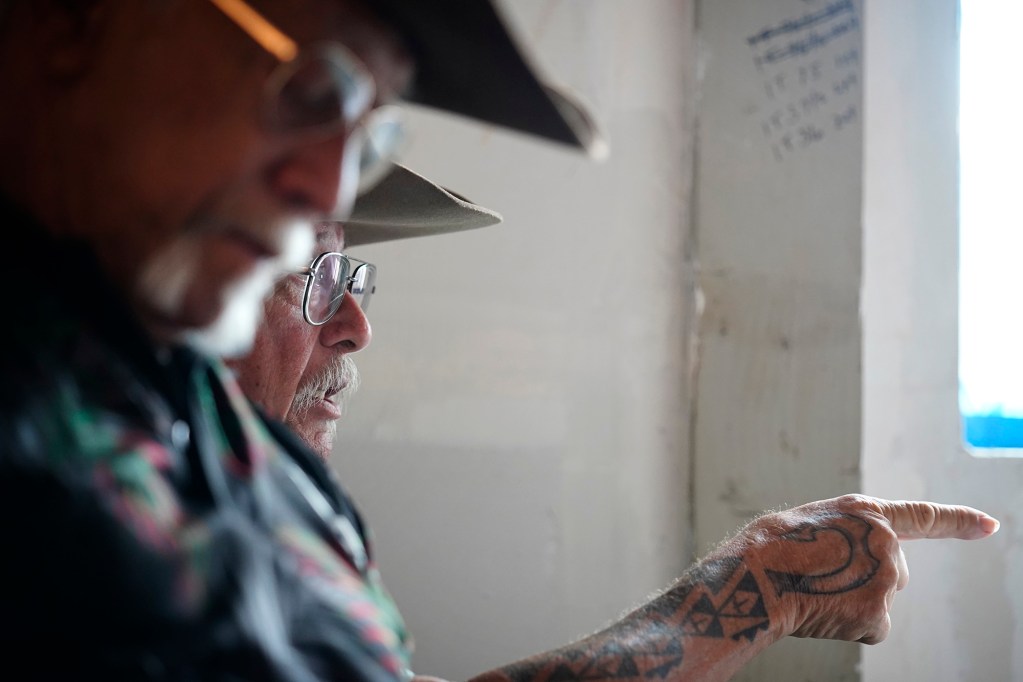 Uncle Phillip “Mango” Stephens talks about the state’s imposed tuberculosis quarantine affecting Molokaʻi cattle ranchers Wednesday, May 27, 2026, in Kaunakakai. Sitting to his right is Uncle Jimmy Duvauchelle. (Kevin Fujii/Civil Beat/2026)