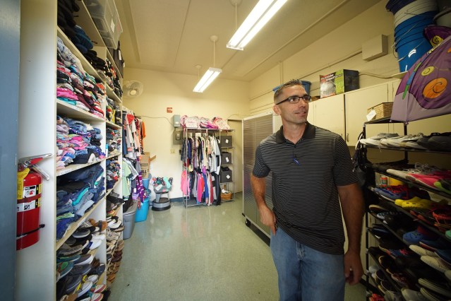 Waipahu Elementary School VP James Suster stands inside Auntie Carolyns closet, where students can get some donated clothes.