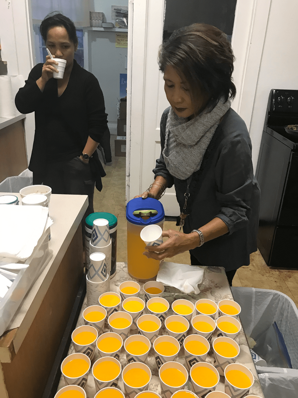 Lisa Shin pours orange juice for kids who attend the Lanai Baptist Church free breakfast every Wednesday.