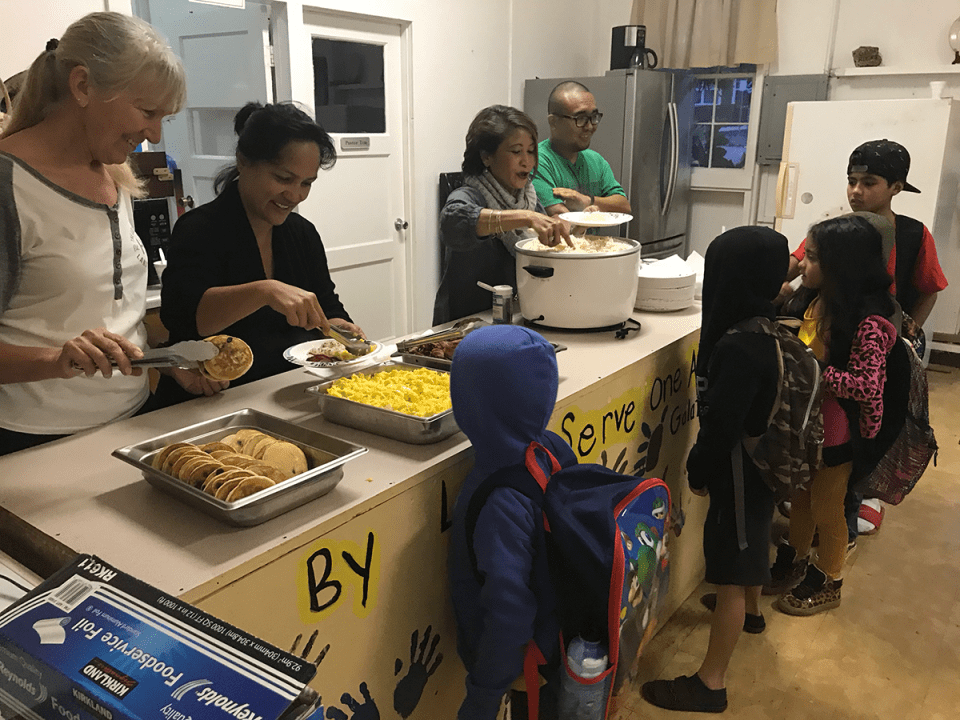 Volunteers Lisa Shin, Debbie Wheeler and Josh Ige serve a free breakfast to kids at Lanai Baptists Church. The church offers the breakfast every Wednesday.