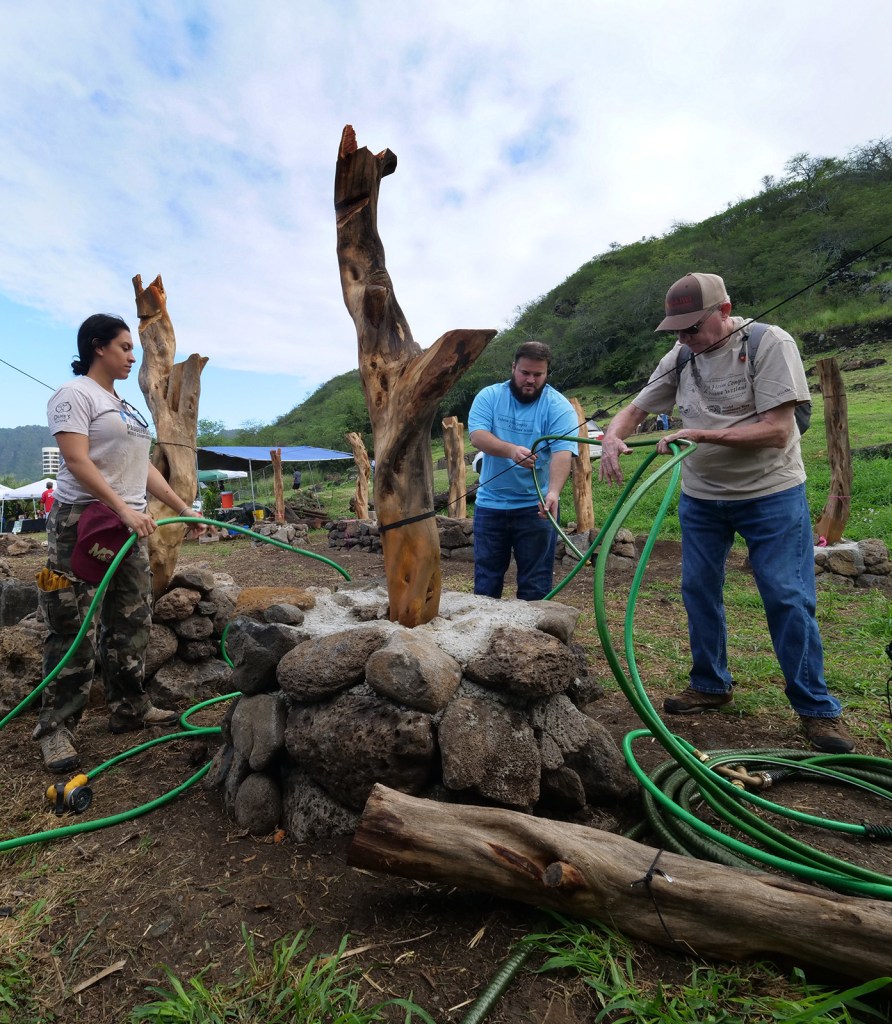 Carl Shaad (right), Ian Heilbronn (center), and Pualei Monokini-Oliveira (left) work to build a community hale at the Hawea Heiau Complex & Keawawa Wetland in Hawaii Kai, Oahu, Saturday, February 8, 2020. Community volunteers gathered there to celebrate the 2020 World Wetlands Day - one of 800 such events worldwide.  The second Saturday of every month the Keawawa heritage preserve is open from 8:30 to noon for maintenance of the wetland. The public is welcome to visit and volunteer. (CivilBeat photo Ronen Zilberman)