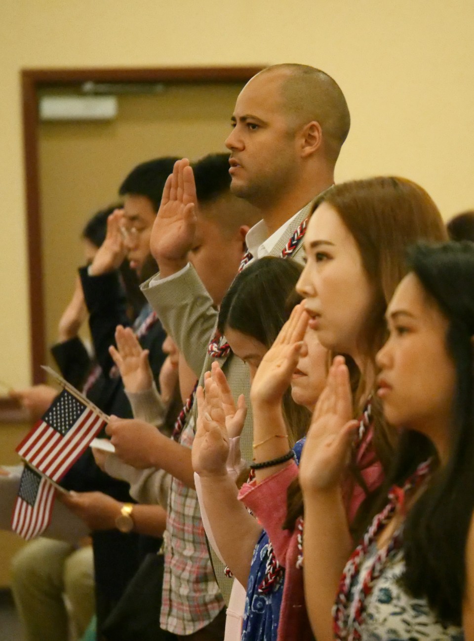 Approximately 50 citizenship applicants raised their hands to pledge allegiance and be sworn in as new US citizens during a naturalization ceremony at Iolani School in Honolulu, HI, on Wednesday, February 12, 2020. 