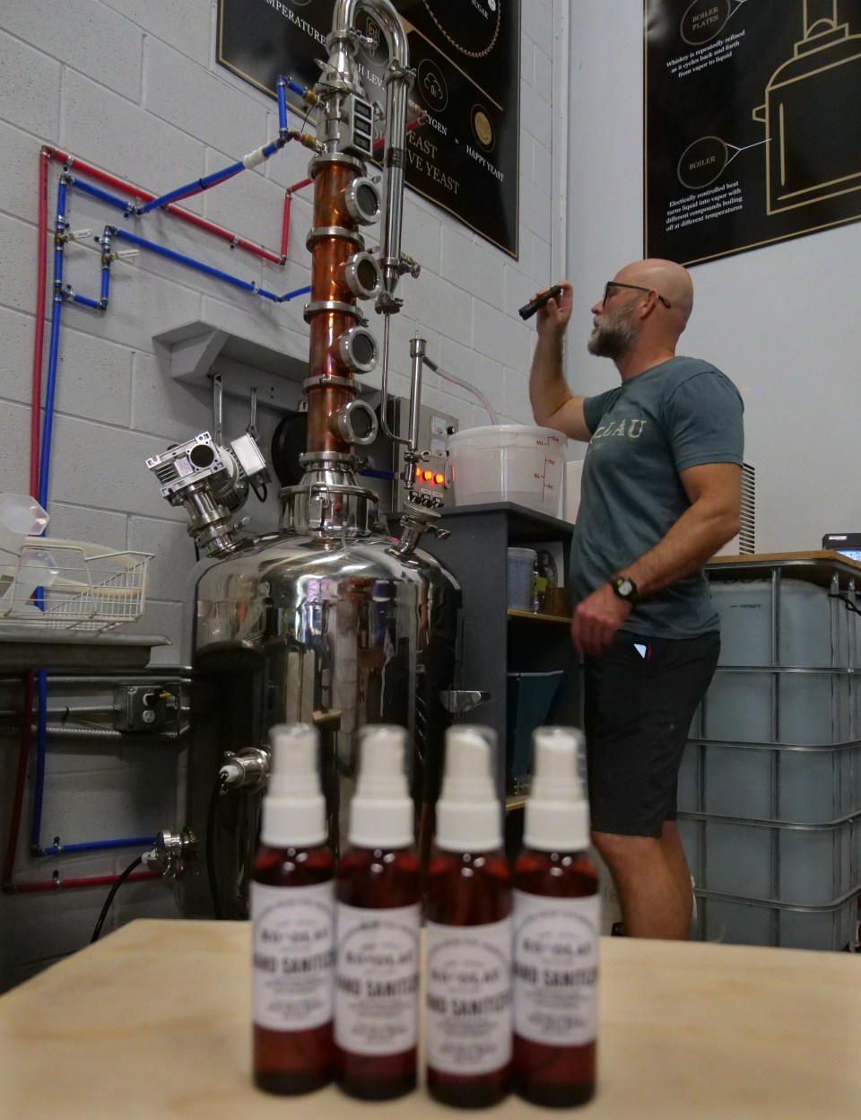 Ko'olau Distillery partner/CEO, Eric Dill, checks the temperature on a batch of hand sanitizer at their distillery in Kailua, HI, Friday, April 3, 2020.  The local based company has stopped whiskey production to dedicate operations to making and donating hand sanitizers to first responders, healthcare workers, and civil service providers.  (Ronen Zilberman photo Civil Beat)