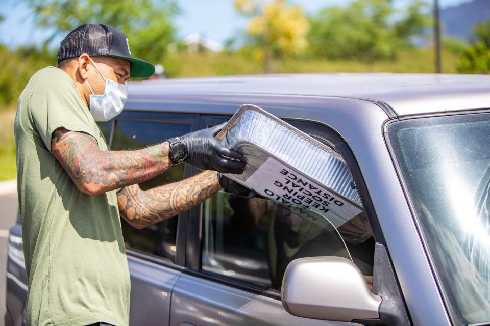 At a mask drive in Maili, volunteers from Hands In Helping Out distributed 5,000 disposable face masks acquired by Every1ne Hawaii. Surfer Ha'a Keaulana and UFC fighter Yancey Medeiros also helped pass out masks to people arriving by car, bike or on foot.