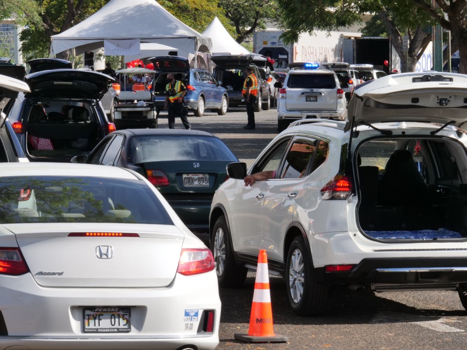 Thousands of local residents lined up for another Show Aloha Challenge at the Aloha Stadium Tuesday, June 2, 2020, in Honolulu, HI. The drive through was their second and largest food distribution event to date as they passed out 2,000 boxes of meats, fresh produce, and keiki snacks. (Ronen Zilberman photo Civil Beat)