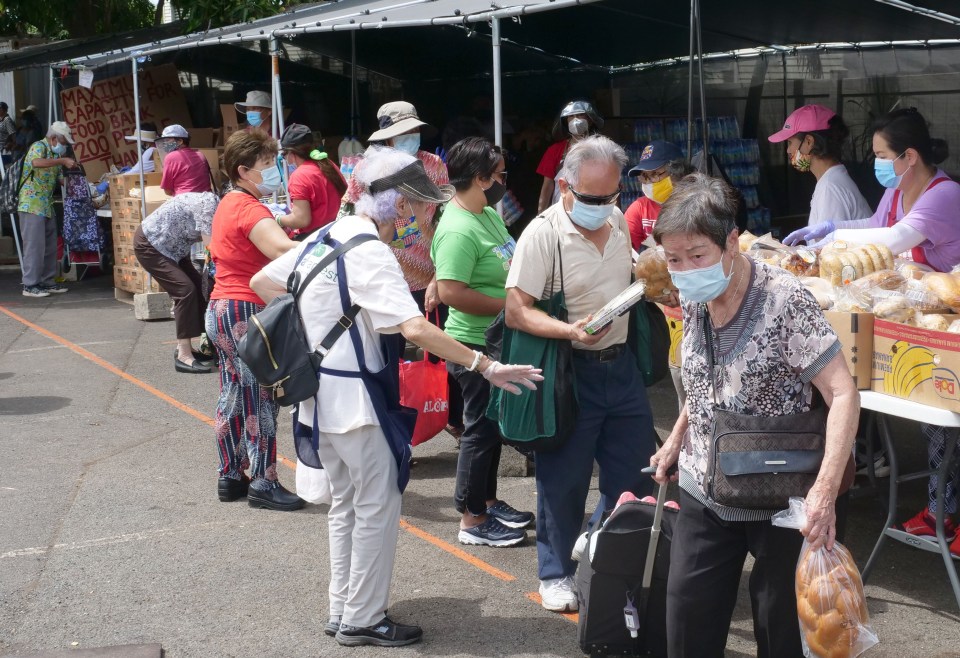 Volunteers pass out food donations to homeless and others in need at the Hawai'i Cedar Church in Kalihi, HI, on Monday, June 8, 2020.  (Ronen Zilberman photo Civil Beat)